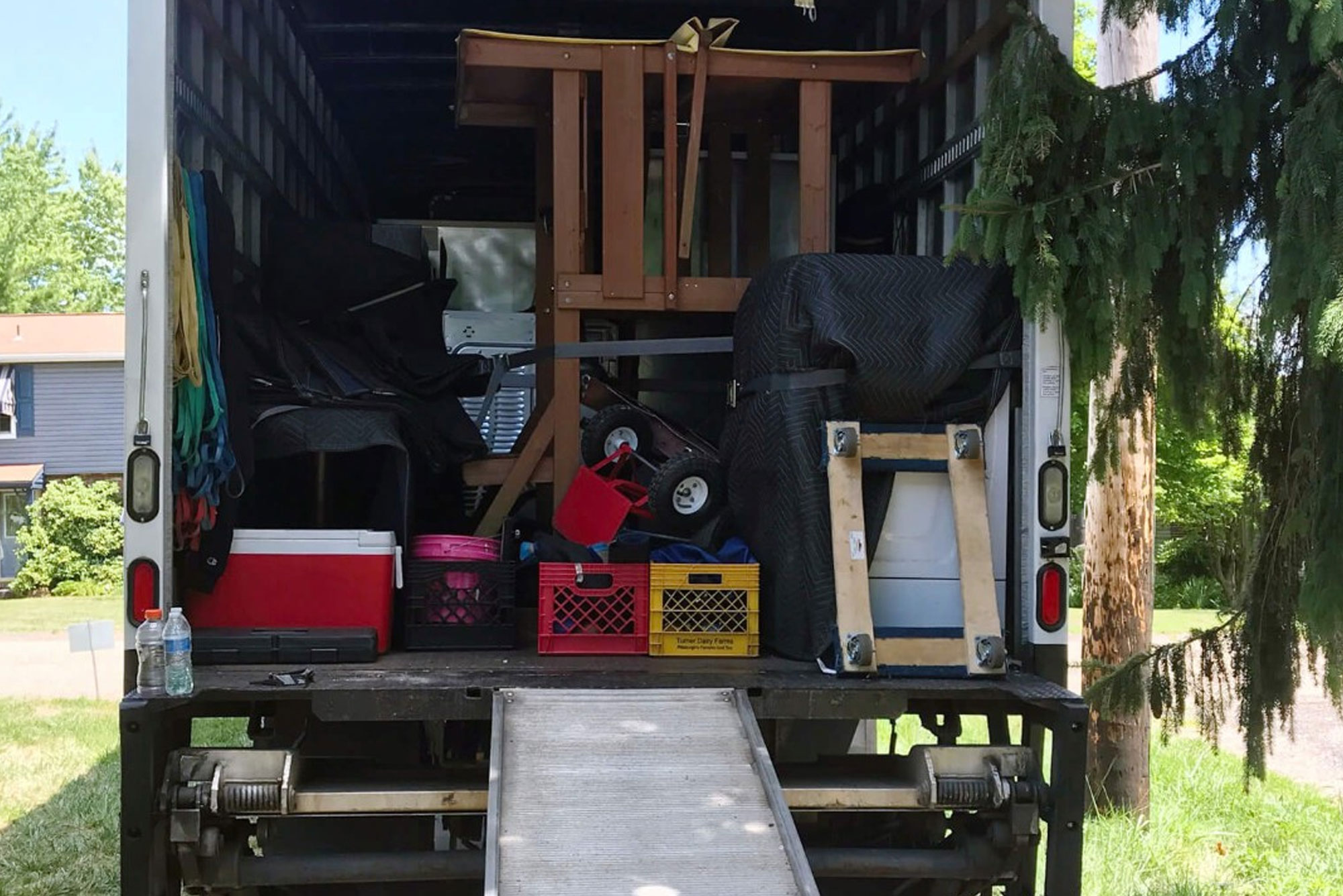 Truck loaded with furniture and a ramp extended
