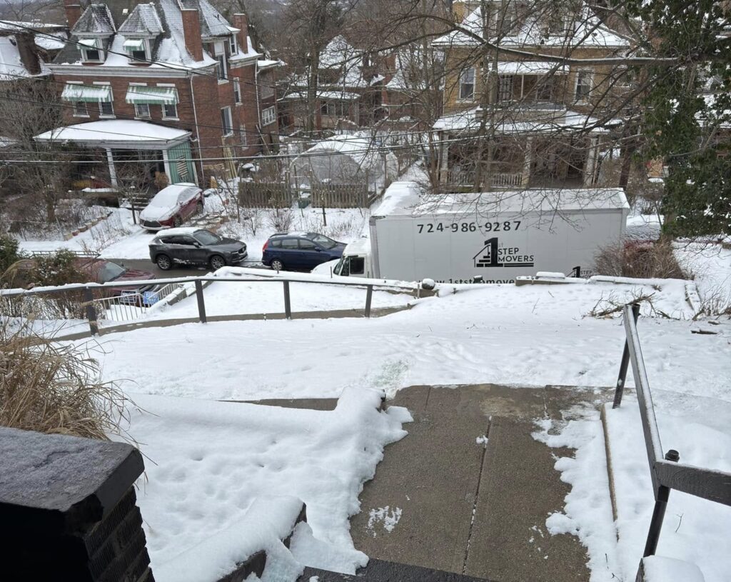 1st Step truck parked on a snowy street in a hillside neighborhood