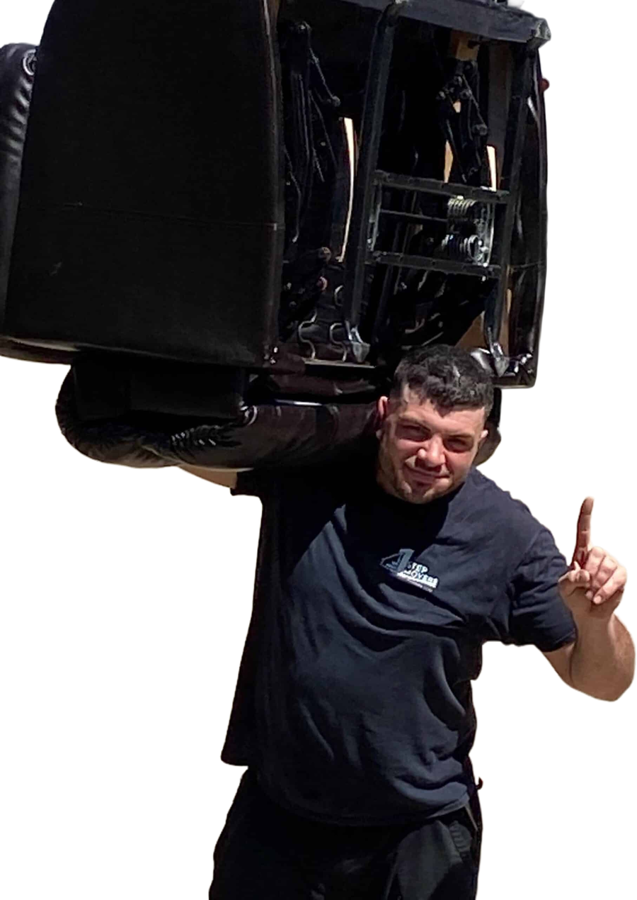 1st Step Movers crew member carrying a recliner on his shoulder